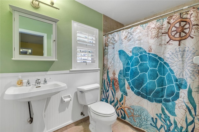 bathroom with sink, tile patterned floors, toilet, and walk in shower