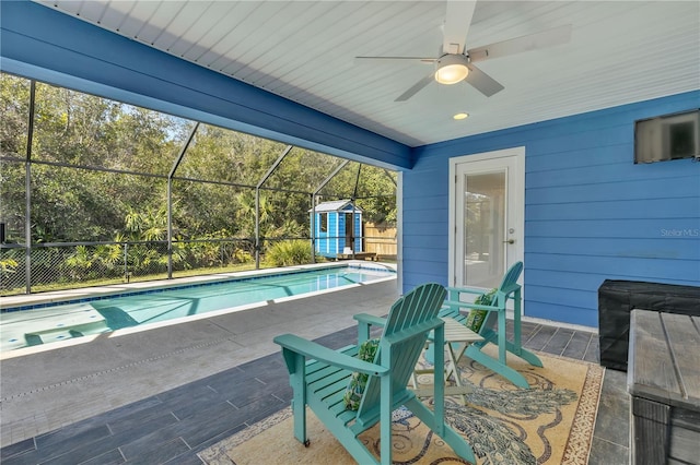 view of pool with a patio and ceiling fan