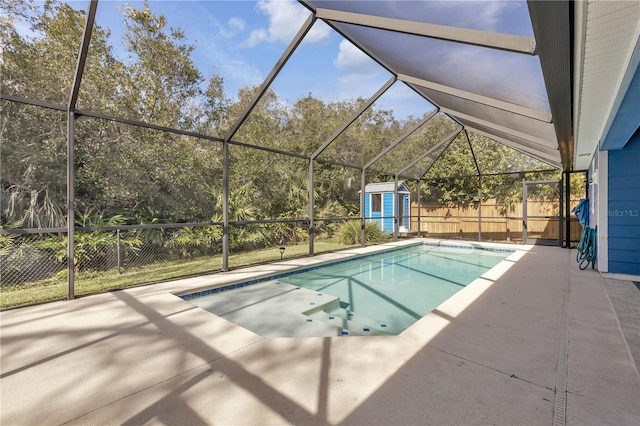 view of swimming pool with a patio area, glass enclosure, and a shed