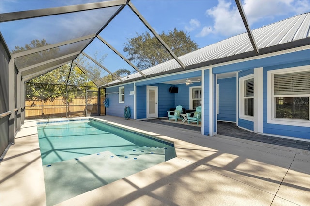 view of pool featuring ceiling fan, a patio, and glass enclosure