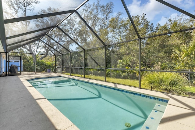 view of swimming pool featuring a patio and a lanai