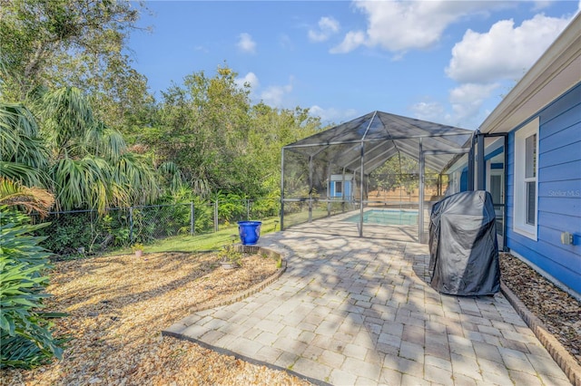 view of patio / terrace with a lanai and area for grilling