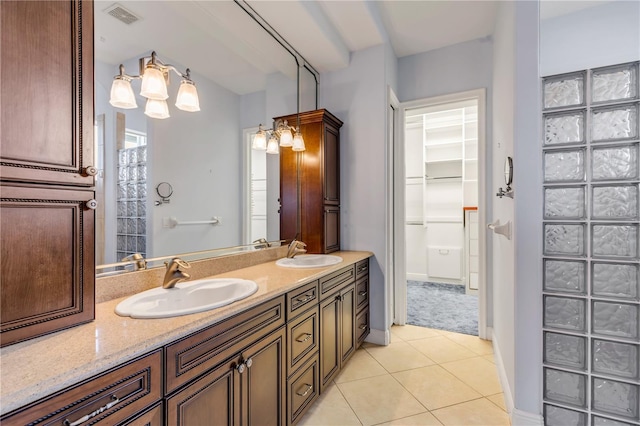 bathroom featuring tile patterned flooring and vanity