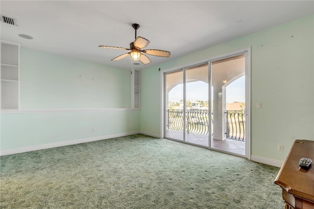 carpeted empty room featuring ceiling fan