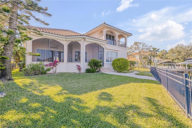 mediterranean / spanish-style home with a balcony and a front yard