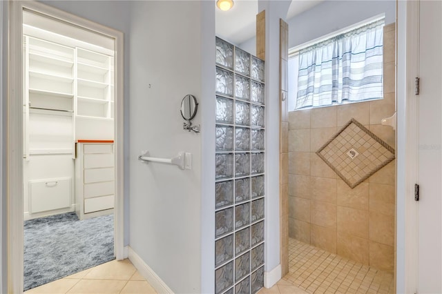 bathroom with tile patterned floors and tiled shower