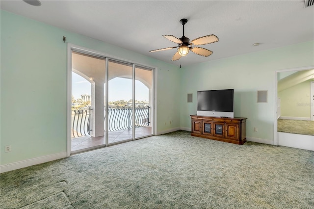 unfurnished living room featuring light carpet and ceiling fan