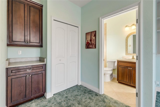 bathroom with vanity, tile patterned flooring, and toilet