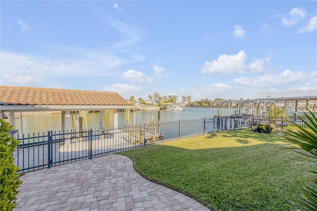 view of dock featuring a yard and a water view