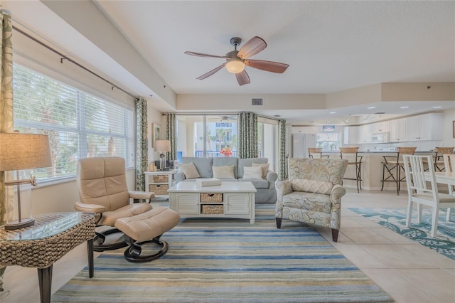 tiled living room with ceiling fan