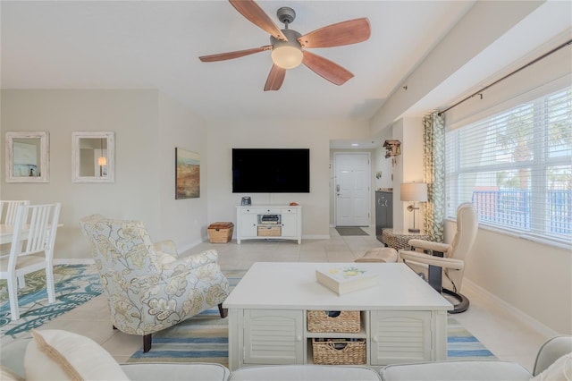 tiled living room with ceiling fan