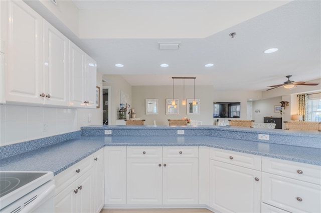 kitchen featuring white cabinetry, decorative backsplash, hanging light fixtures, electric range, and ceiling fan