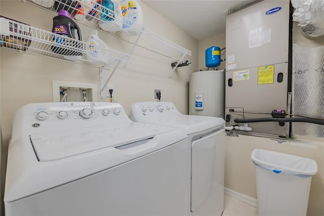 laundry room with heating unit, washing machine and dryer, and water heater