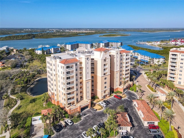 drone / aerial view featuring a water view and a city view