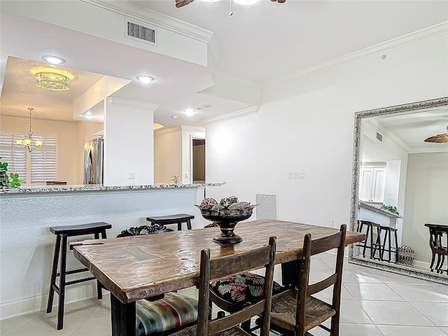 dining space with light tile patterned flooring, visible vents, and crown molding