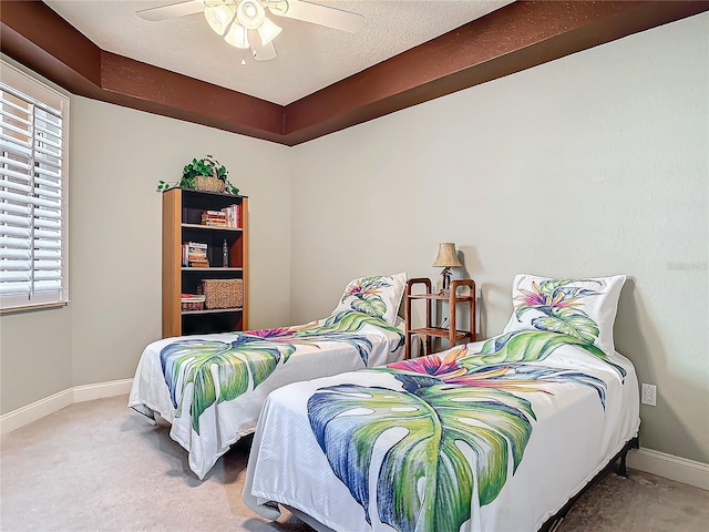 bedroom with carpet, baseboards, ceiling fan, and a textured ceiling