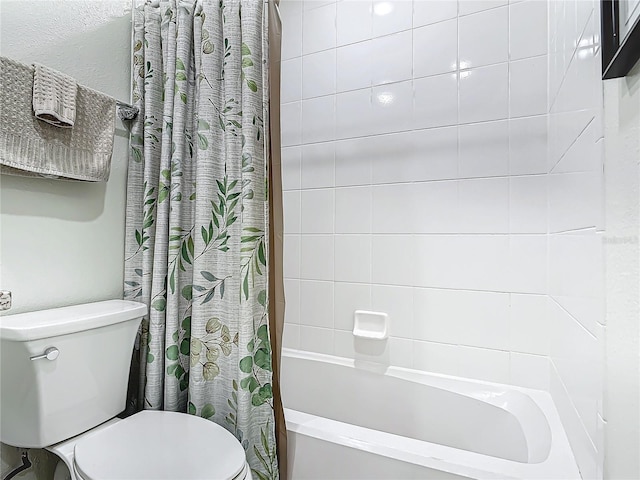 bathroom with toilet and shower / bath combo with shower curtain