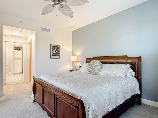 bedroom featuring light carpet, ceiling fan, visible vents, and baseboards