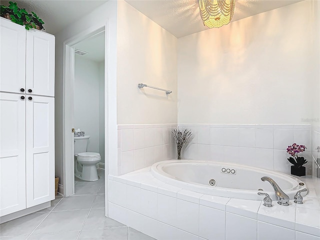 bathroom with a whirlpool tub, visible vents, tile patterned flooring, and toilet