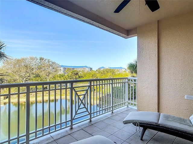 balcony with ceiling fan and a water view