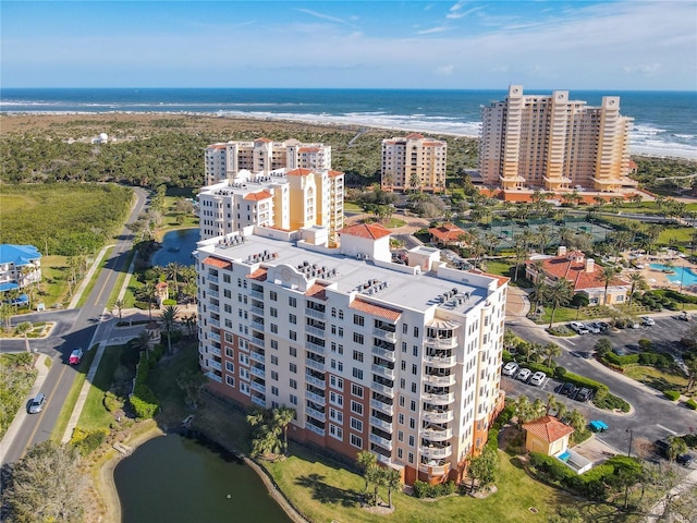 drone / aerial view featuring a view of city and a water view