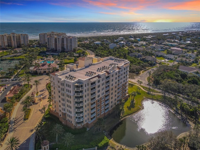 birds eye view of property with a water view and a city view