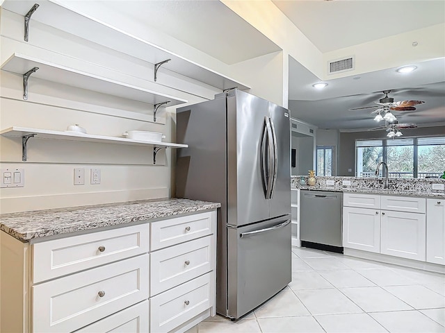 kitchen featuring light tile patterned floors, visible vents, light stone countertops, stainless steel appliances, and open shelves