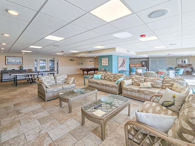 living room featuring a drop ceiling