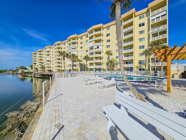 exterior space featuring a water view and a community pool