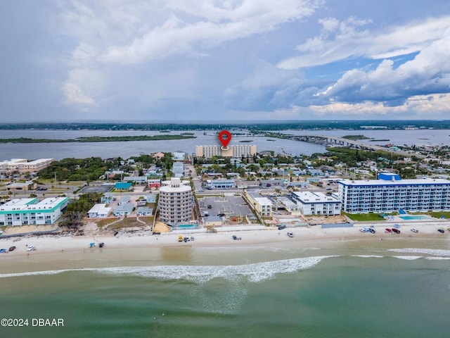 bird's eye view with a water view and a beach view