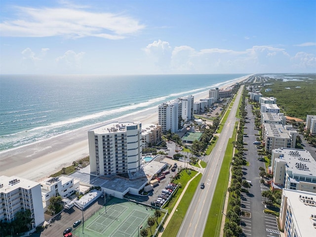 birds eye view of property featuring a water view and a beach view