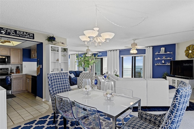 dining room featuring light tile patterned flooring, ceiling fan with notable chandelier, and a textured ceiling