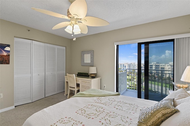 carpeted bedroom with ceiling fan, a closet, and a textured ceiling