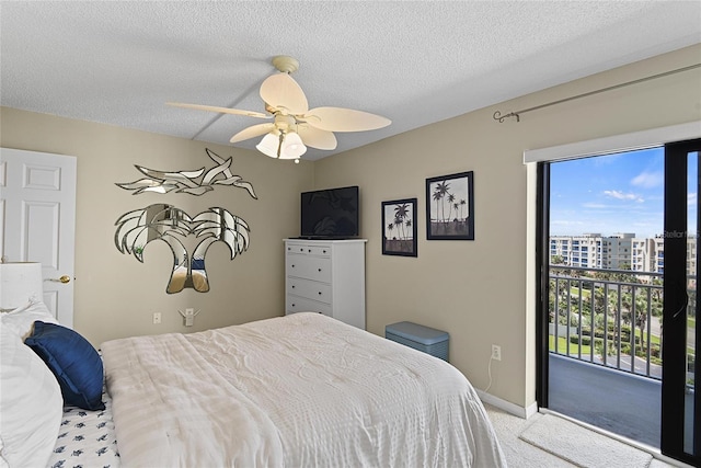 carpeted bedroom with ceiling fan, access to exterior, and a textured ceiling