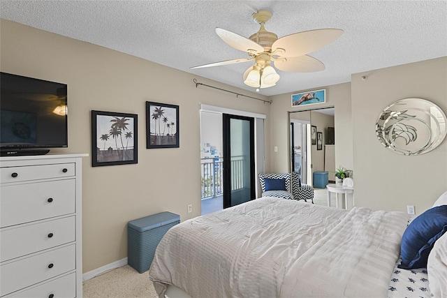 bedroom featuring light carpet, access to exterior, a textured ceiling, and ceiling fan