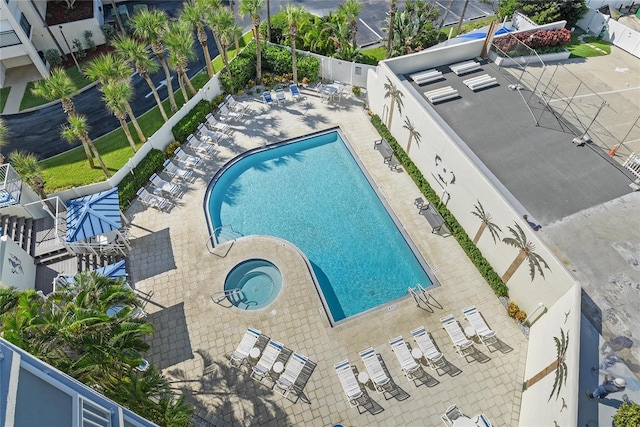 view of pool with a patio and a community hot tub