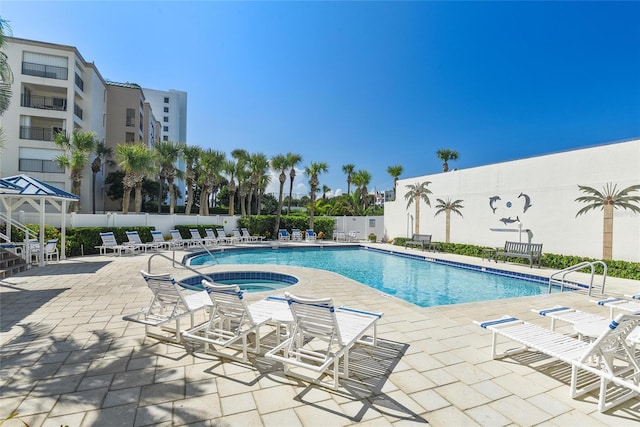 view of pool featuring a hot tub and a patio