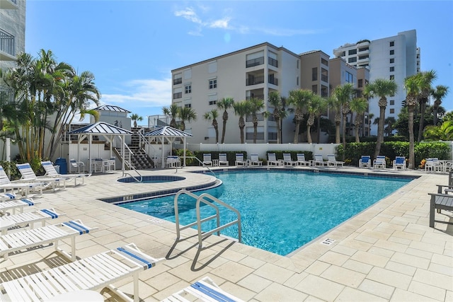 view of pool featuring a patio area and a hot tub