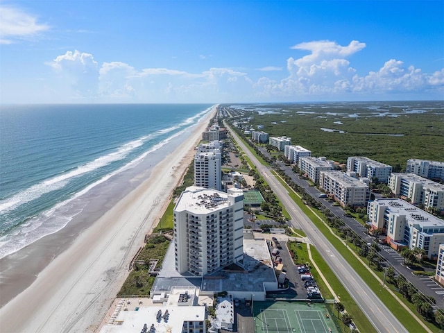 drone / aerial view featuring a water view and a beach view