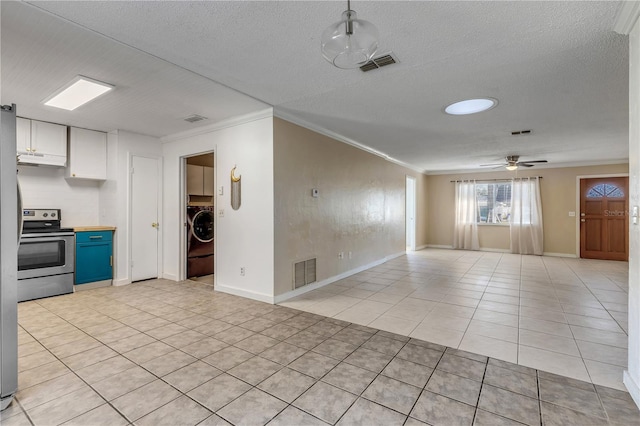 interior space with white cabinetry, light tile patterned floors, ornamental molding, electric stove, and washer / clothes dryer