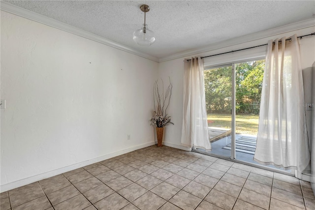 tiled spare room with ornamental molding and a textured ceiling