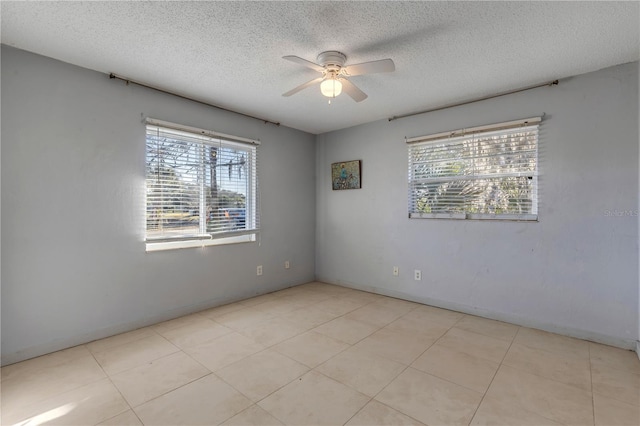 empty room with a textured ceiling and ceiling fan