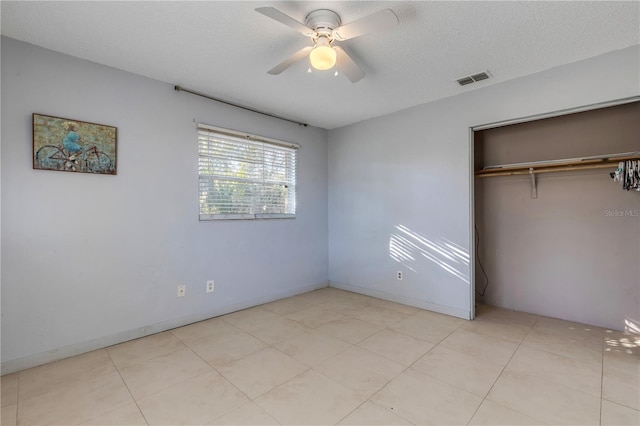 unfurnished bedroom featuring ceiling fan, a closet, and a textured ceiling