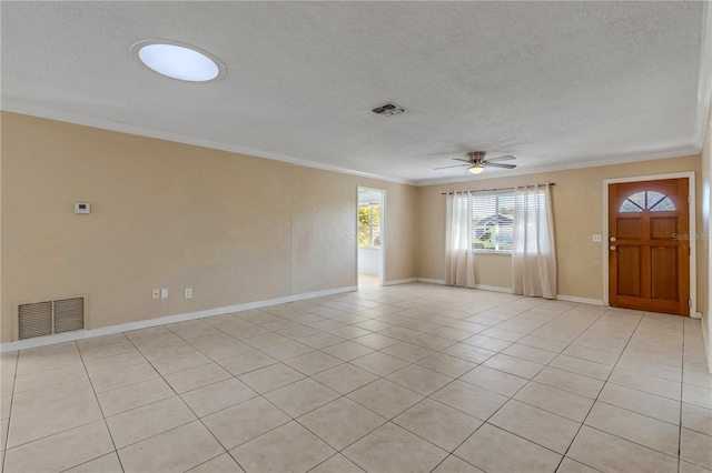 tiled empty room featuring crown molding, ceiling fan, and a textured ceiling