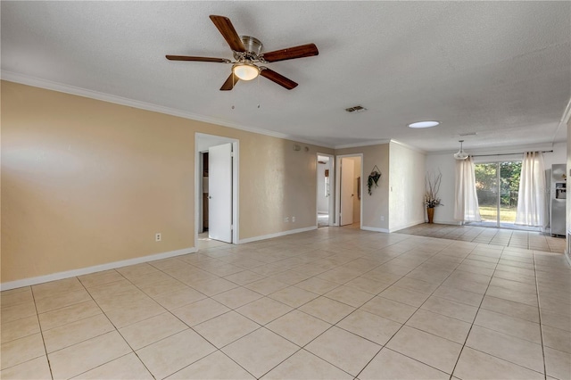 empty room featuring light tile patterned floors, ornamental molding, and a textured ceiling