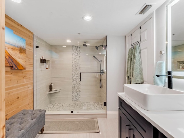 bathroom featuring vanity and a shower with shower door