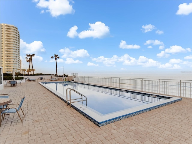 view of swimming pool featuring a patio