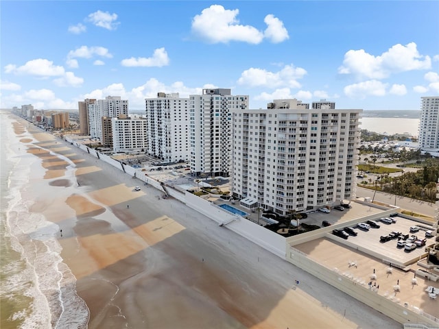 bird's eye view with a water view and a view of the beach