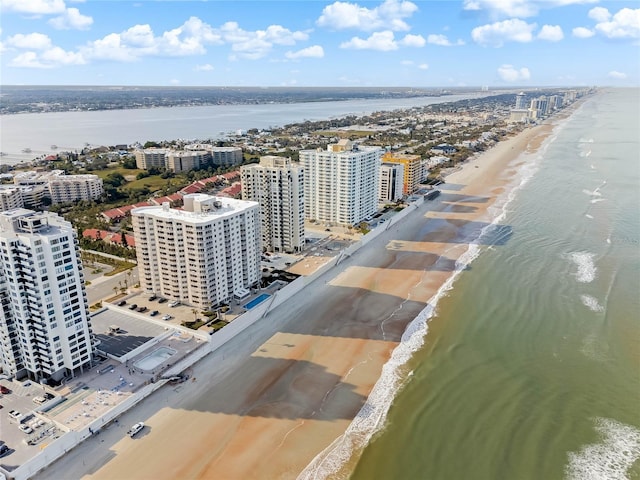 drone / aerial view featuring a water view and a beach view