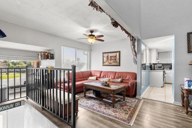 living room with wood-type flooring, a healthy amount of sunlight, and ceiling fan